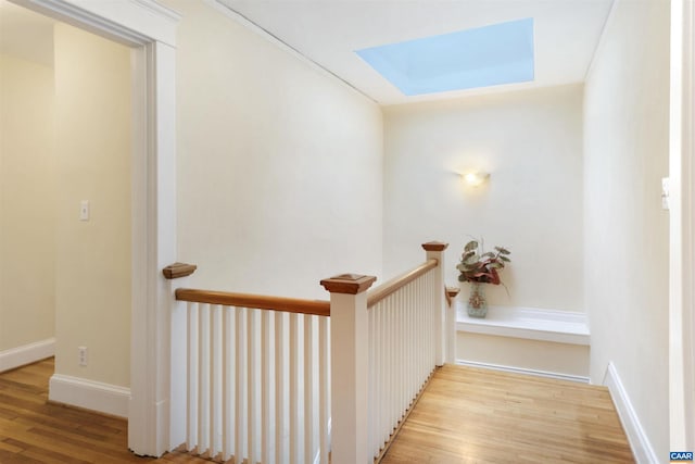 interior space with a skylight and light wood-type flooring