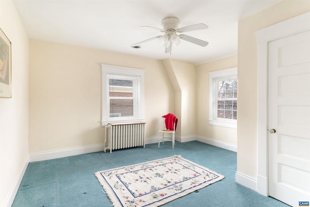 bonus room with carpet, radiator heating unit, and ceiling fan