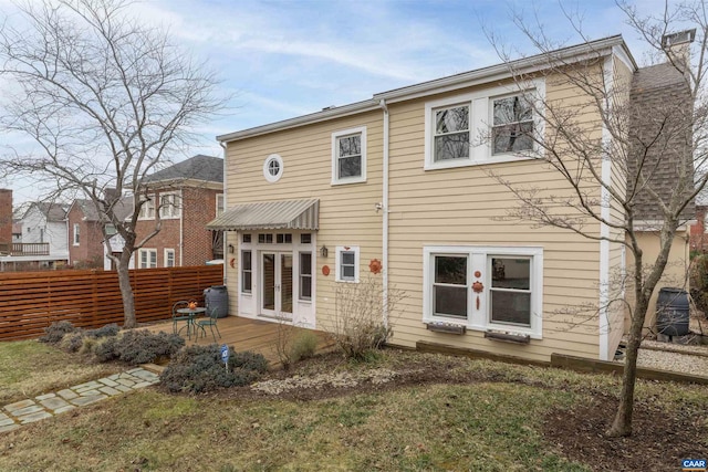 rear view of property featuring a wooden deck and a yard