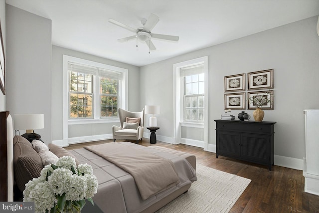 bedroom with ceiling fan and dark hardwood / wood-style flooring