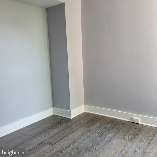 spare room with dark hardwood / wood-style floors