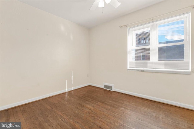 spare room featuring wood-type flooring and ceiling fan