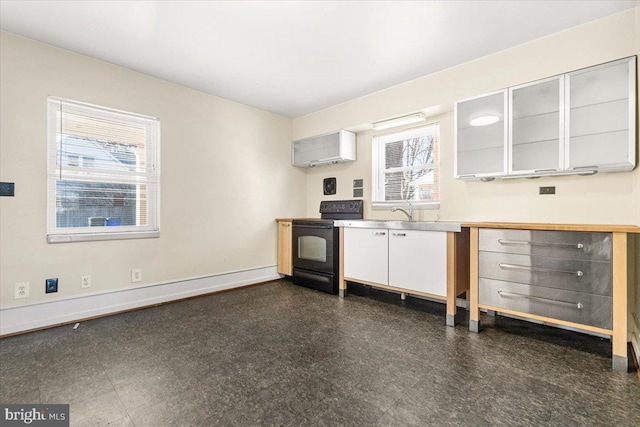 kitchen with black electric range oven and gray cabinetry