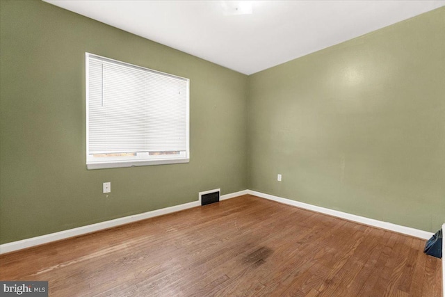 unfurnished room featuring wood-type flooring