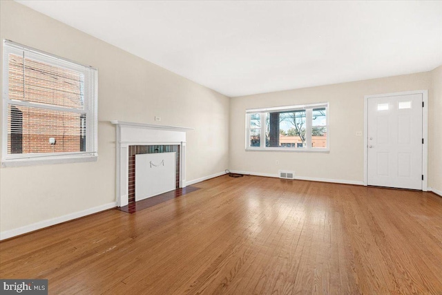 unfurnished living room featuring hardwood / wood-style flooring