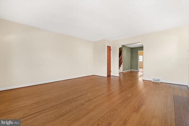 empty room with hardwood / wood-style floors