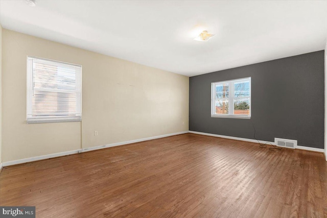 unfurnished room featuring hardwood / wood-style flooring