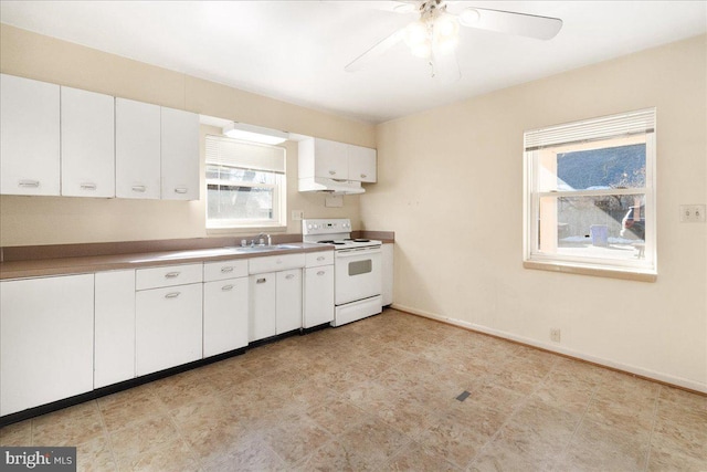 kitchen with sink, white electric stove, white cabinets, and ceiling fan