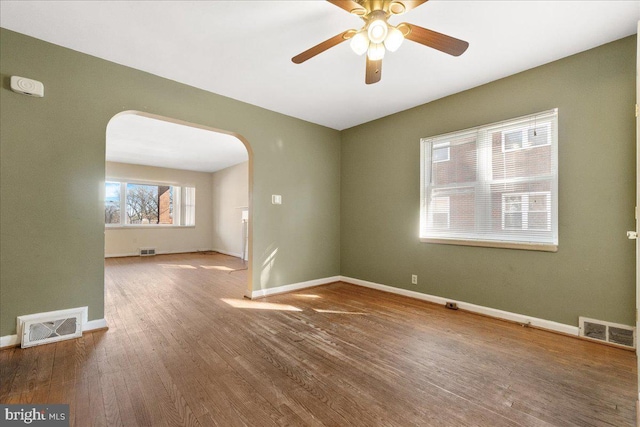 empty room featuring hardwood / wood-style flooring and ceiling fan