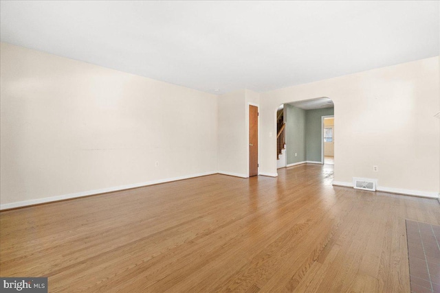 spare room with hardwood / wood-style floors