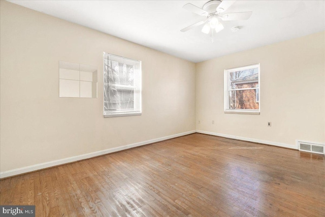 spare room featuring hardwood / wood-style floors and ceiling fan