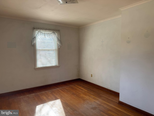 unfurnished room featuring crown molding and hardwood / wood-style flooring