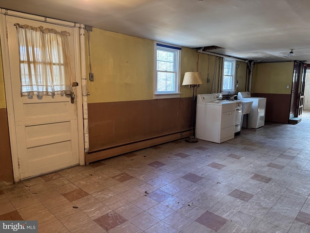 laundry room with a baseboard radiator and washer / clothes dryer