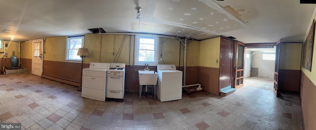 interior space with separate washer and dryer, sink, and a baseboard radiator