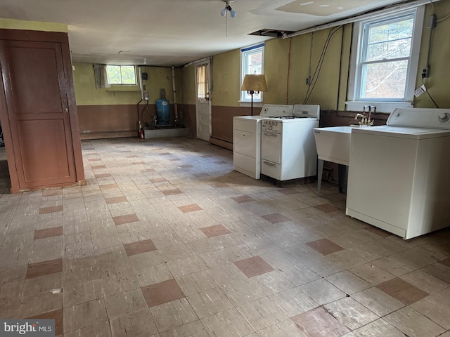 laundry room with plenty of natural light, washer and dryer, and sink