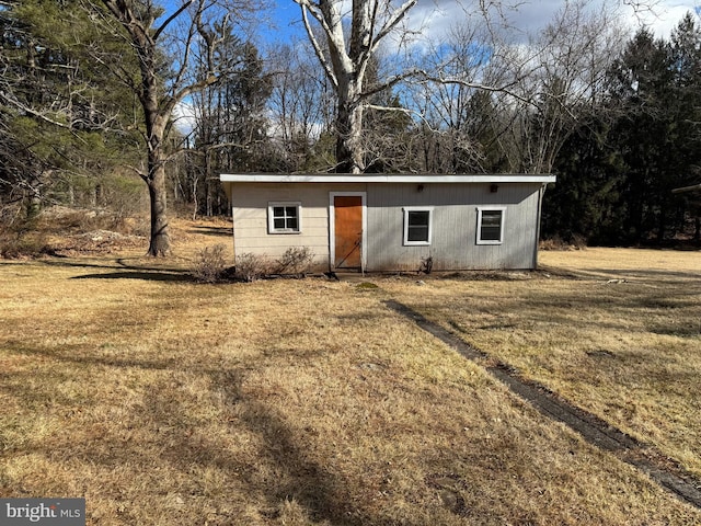 view of outdoor structure featuring a lawn