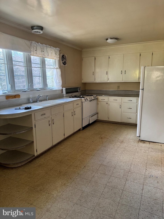 kitchen with white cabinetry, crown molding, sink, and white appliances