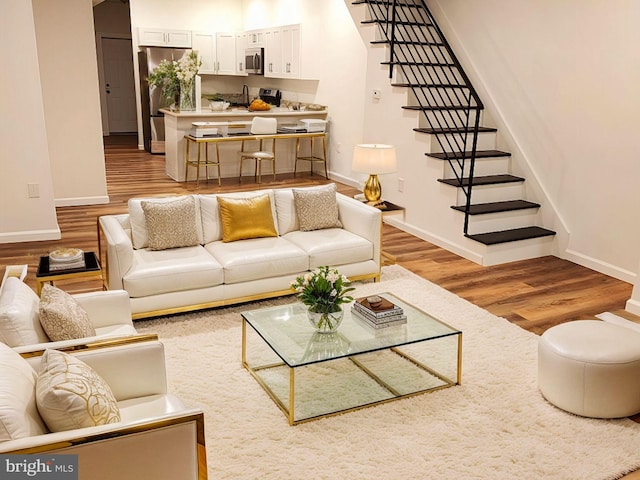 living room with sink and light wood-type flooring