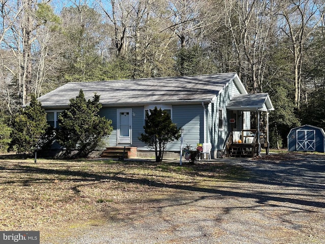 view of front of house featuring entry steps, an outdoor structure, and a storage shed