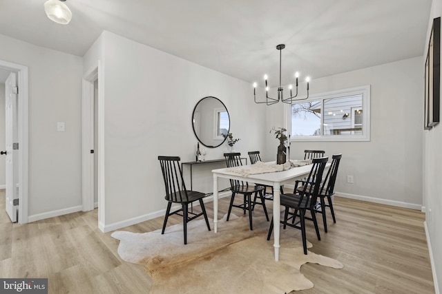 dining room featuring a chandelier and light wood-type flooring