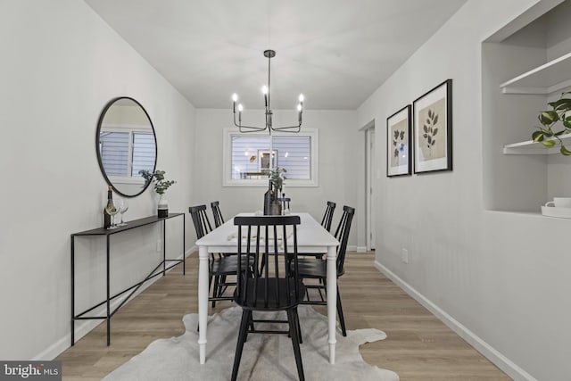 dining room with an inviting chandelier and light hardwood / wood-style floors