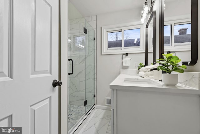 bathroom with walk in shower and vanity