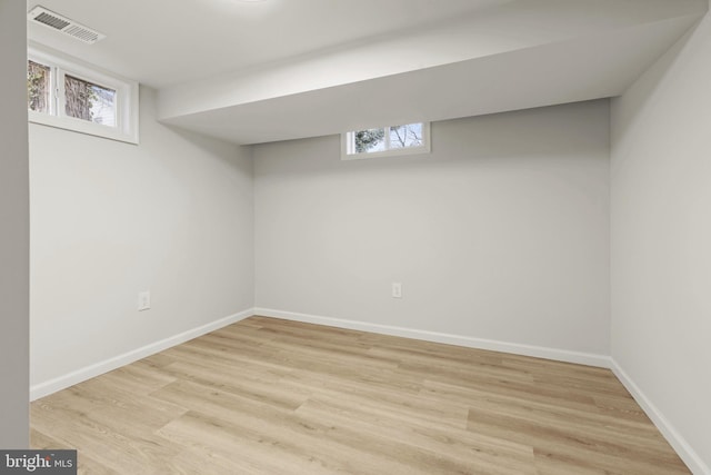 basement with light hardwood / wood-style flooring