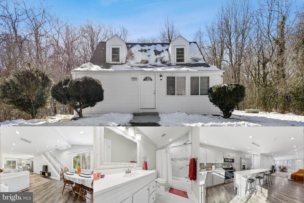 new england style home featuring a wooden deck and a wet bar