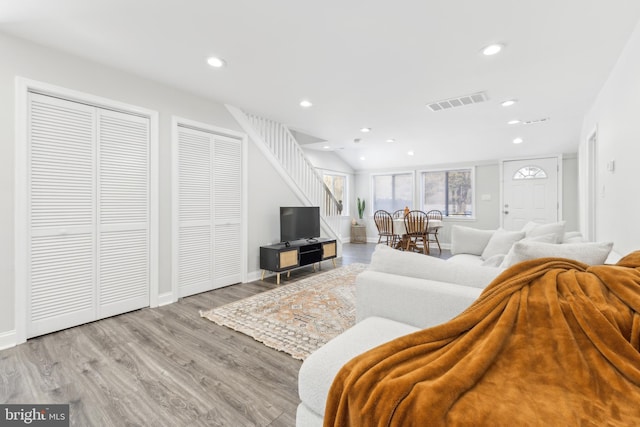 living room with lofted ceiling and light hardwood / wood-style floors