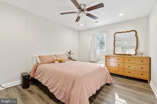 bedroom featuring hardwood / wood-style floors and ceiling fan