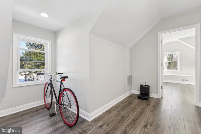 bonus room featuring lofted ceiling and dark hardwood / wood-style flooring