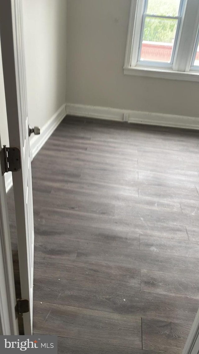 empty room with dark wood-type flooring