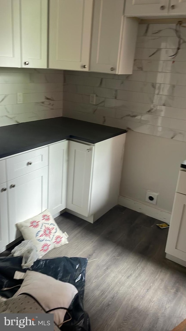 kitchen with light hardwood / wood-style flooring, white cabinets, and decorative backsplash