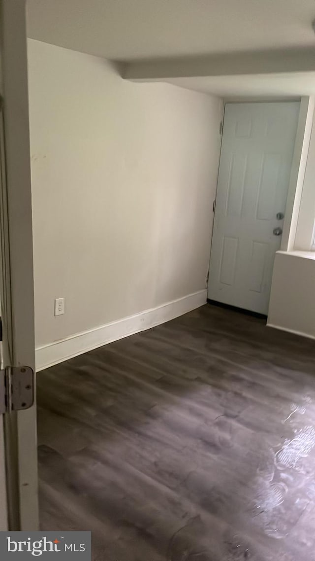 empty room featuring dark hardwood / wood-style flooring