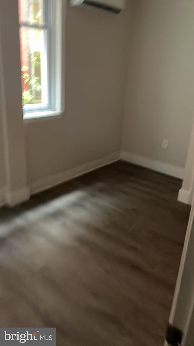 spare room featuring dark hardwood / wood-style floors