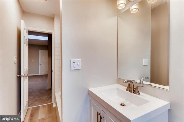 bathroom with hardwood / wood-style flooring and vanity