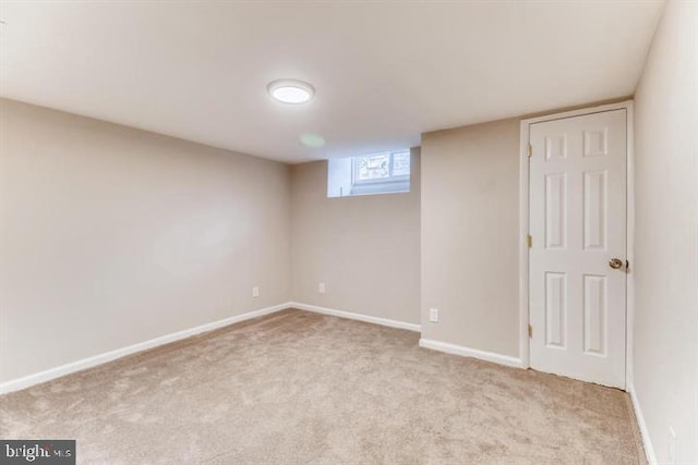 basement featuring light colored carpet