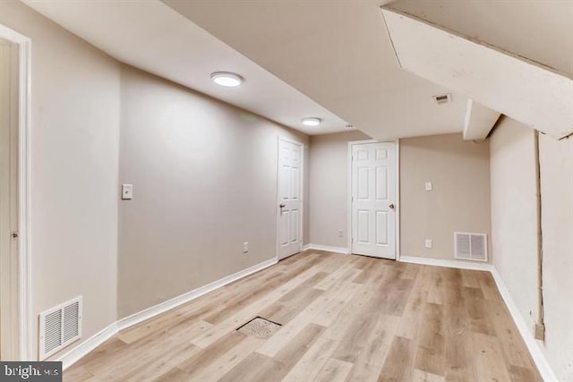 basement with light hardwood / wood-style floors