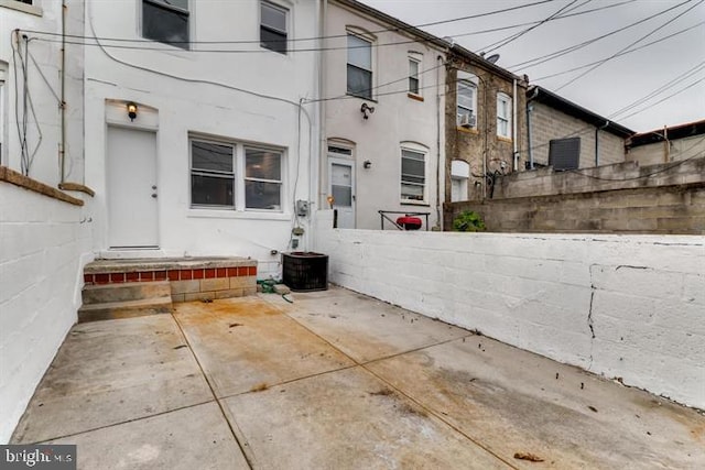 exterior space with cooling unit and a patio