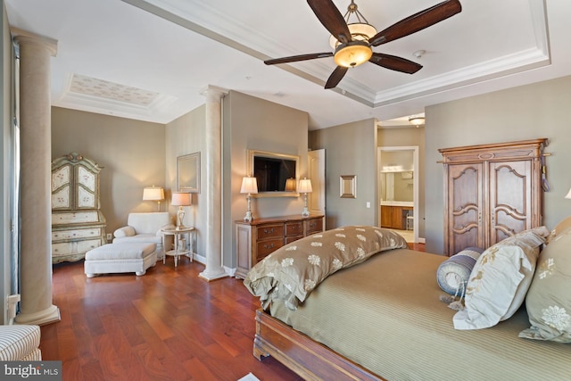 bedroom featuring a raised ceiling, ornamental molding, and decorative columns