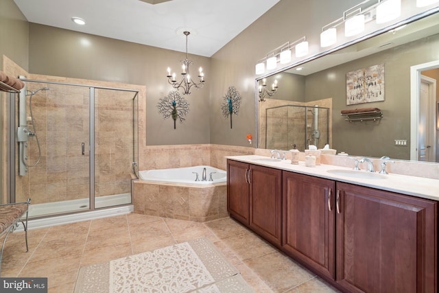 bathroom featuring tile patterned flooring, plus walk in shower, vanity, and an inviting chandelier