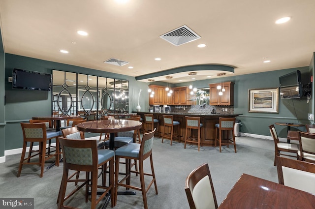 dining space featuring light colored carpet