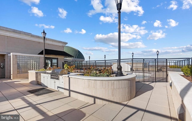 view of patio with grilling area and an outdoor kitchen