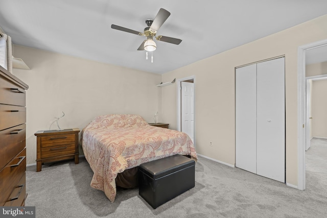 carpeted bedroom with ceiling fan and a closet