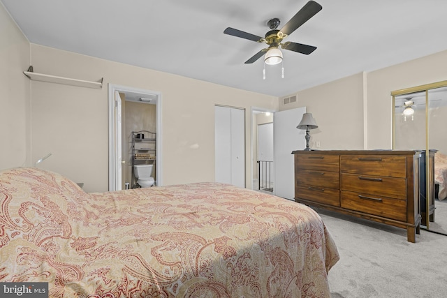 bedroom featuring connected bathroom, light carpet, and ceiling fan