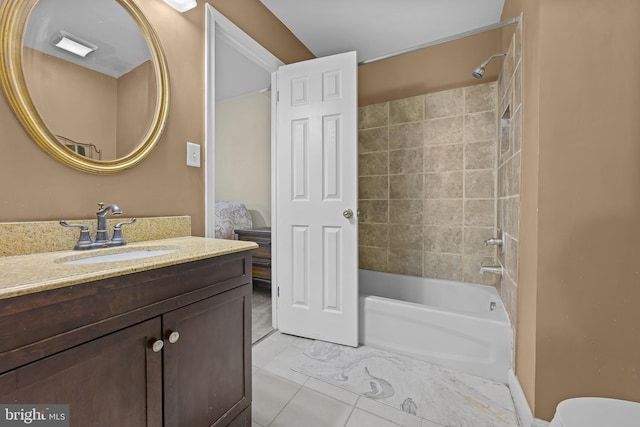 bathroom with vanity, tiled shower / bath combo, and tile patterned floors