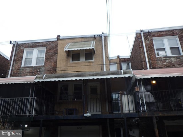 back of house featuring a balcony