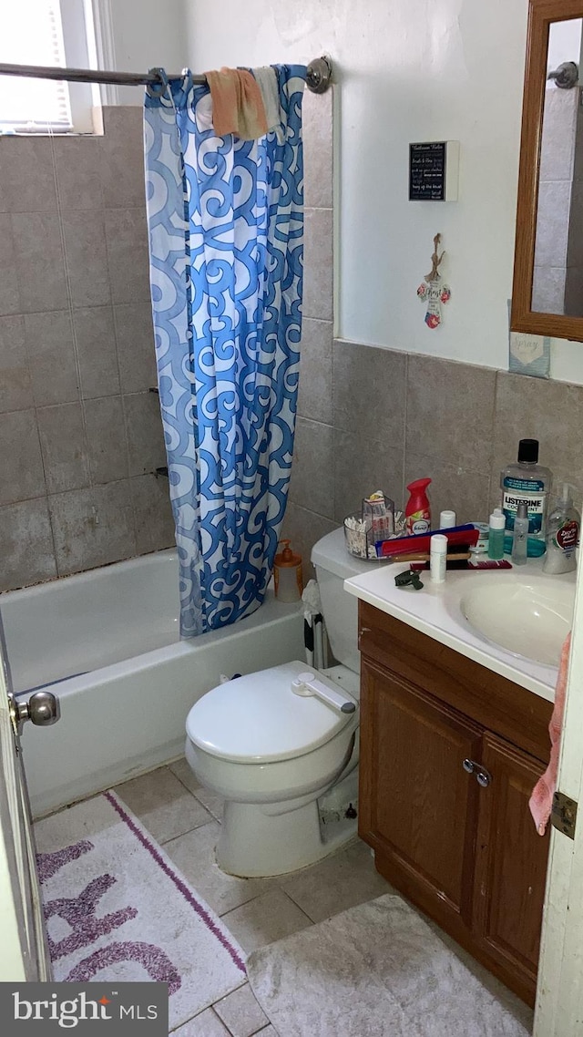 full bathroom featuring tile walls, tile patterned flooring, vanity, toilet, and shower / bathtub combination with curtain