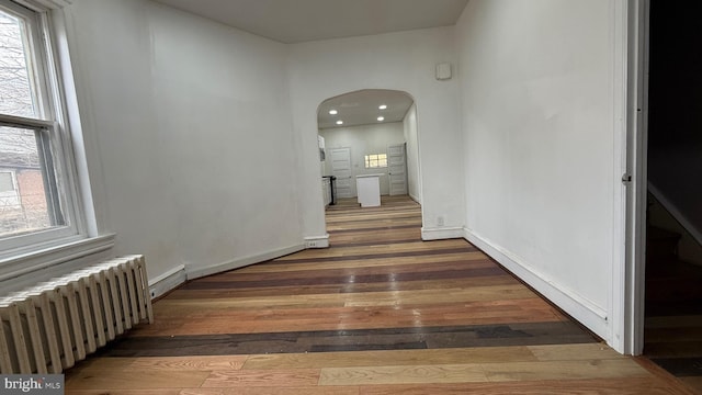 hall featuring radiator and dark wood-type flooring