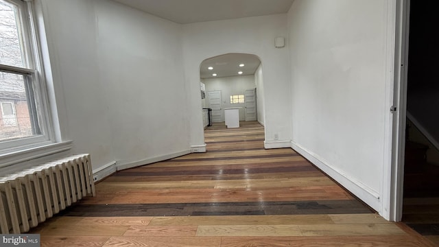 hallway featuring dark hardwood / wood-style floors and radiator heating unit